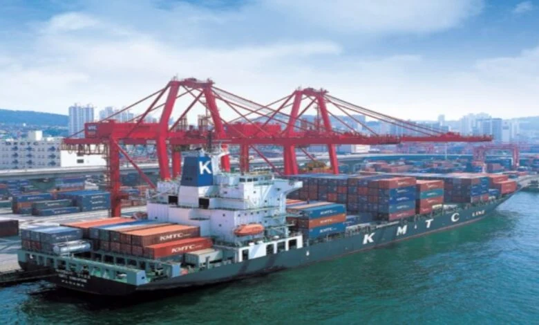 A real photo showing a KMTC container vessel at a port terminal, directly relevant to the news article about KMTC container ship orders.