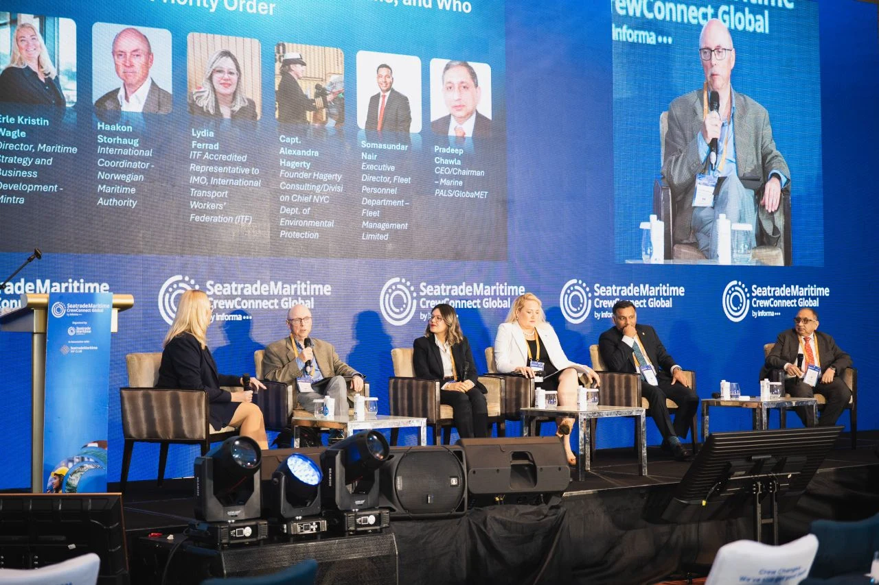 The image shows the panel discussion at the Seatrade Maritime CrewConnect Global conference mentioned in the article, featuring speakers such as Haakon Storhaug, Lydia Ferrad, and Pradeep Chawla.